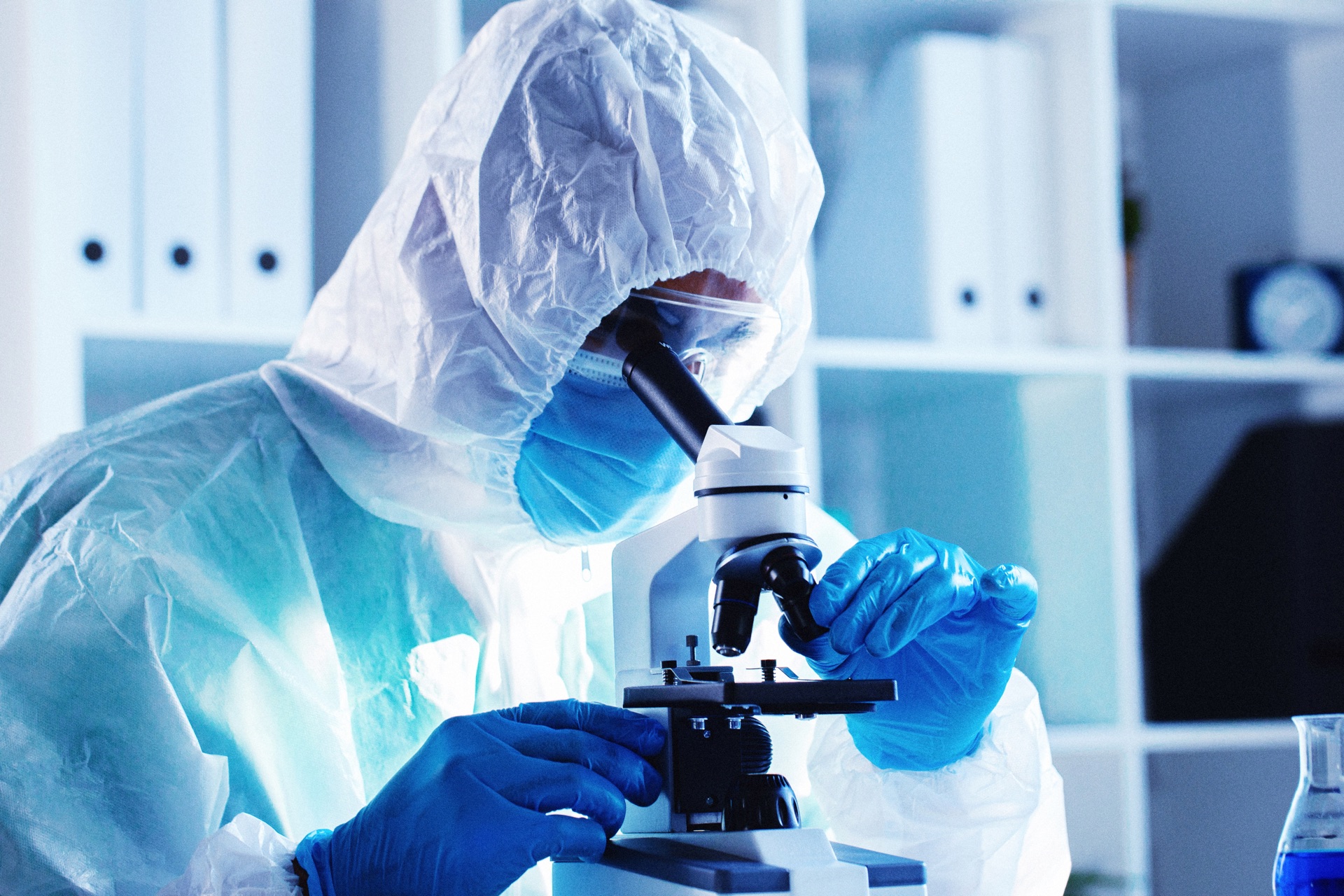 Researcher using a microscope