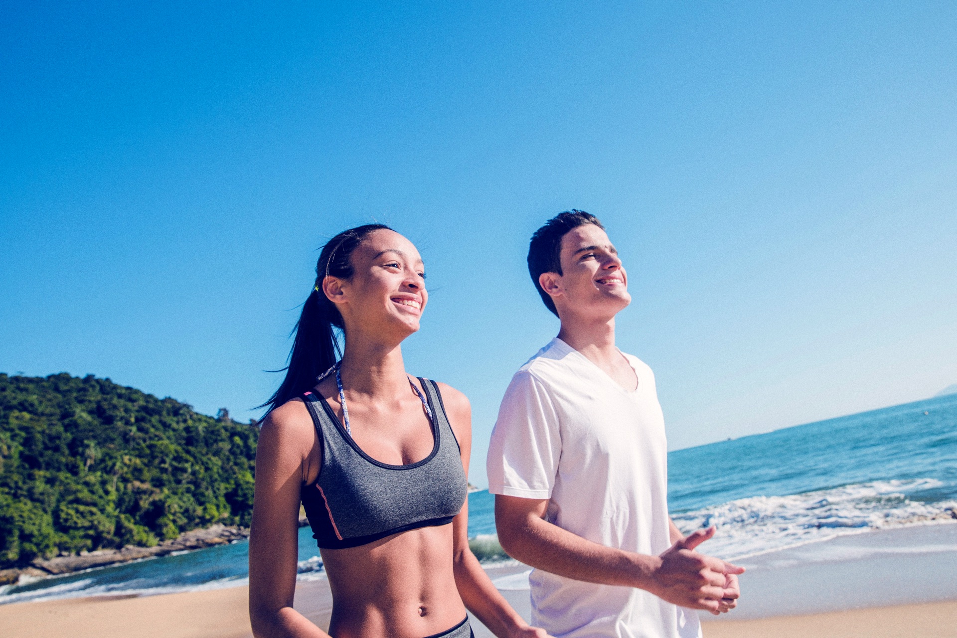 A couple jogging beside the ocean