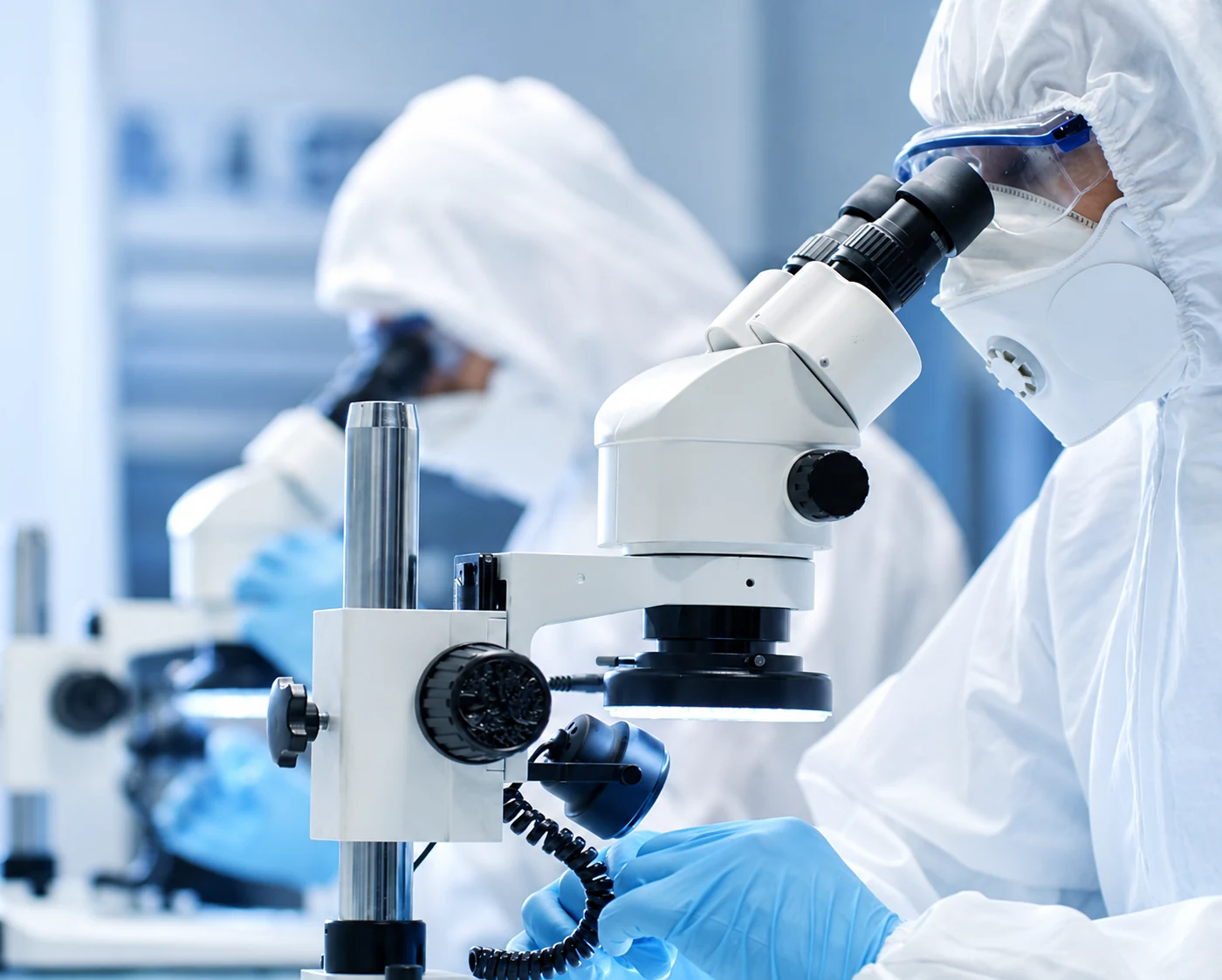 Scientists in protective equipment conducting COVID-19 laboratory research